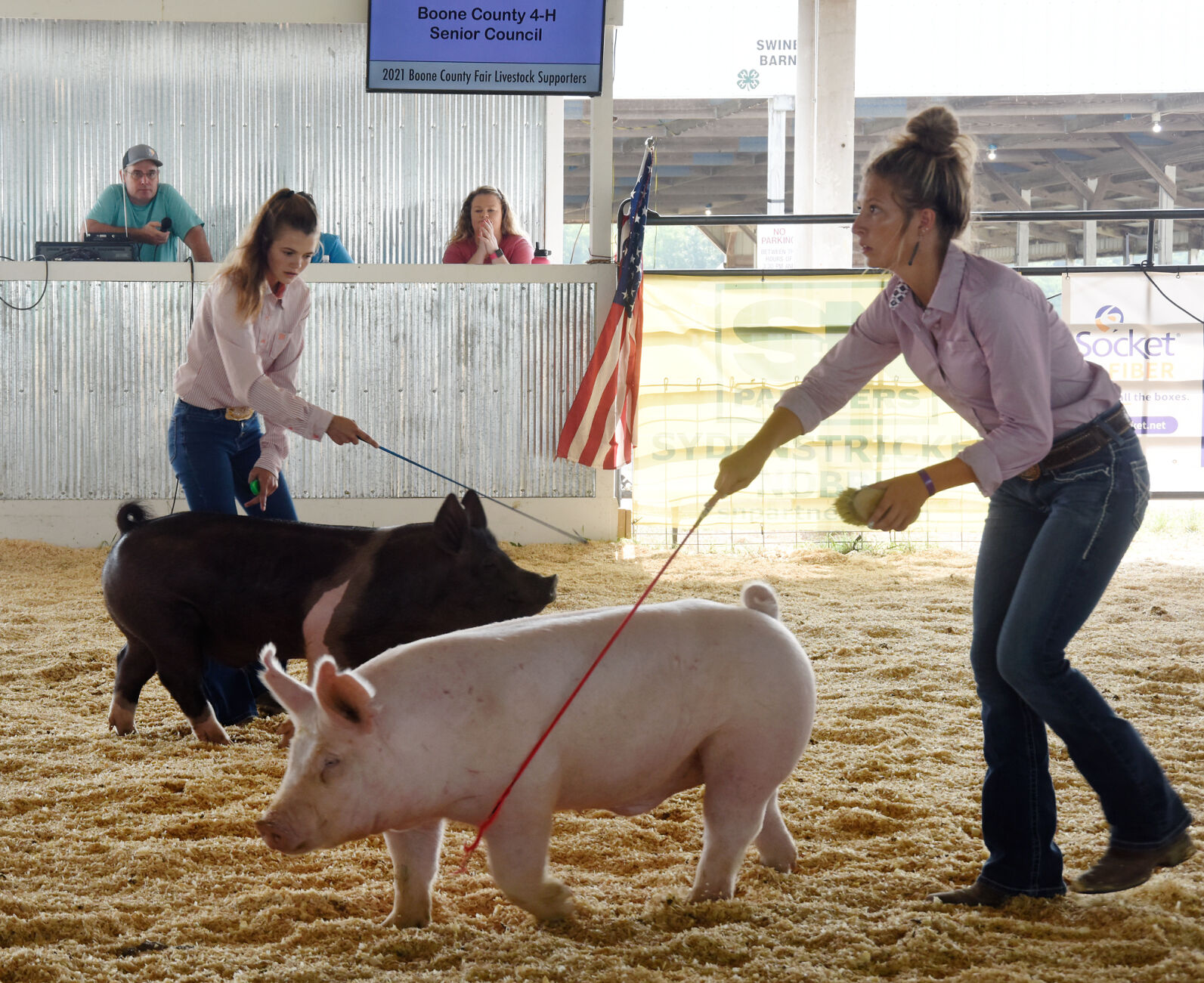 Blair Schnarre and Charlie Hazelrigg direct pigs around the ring